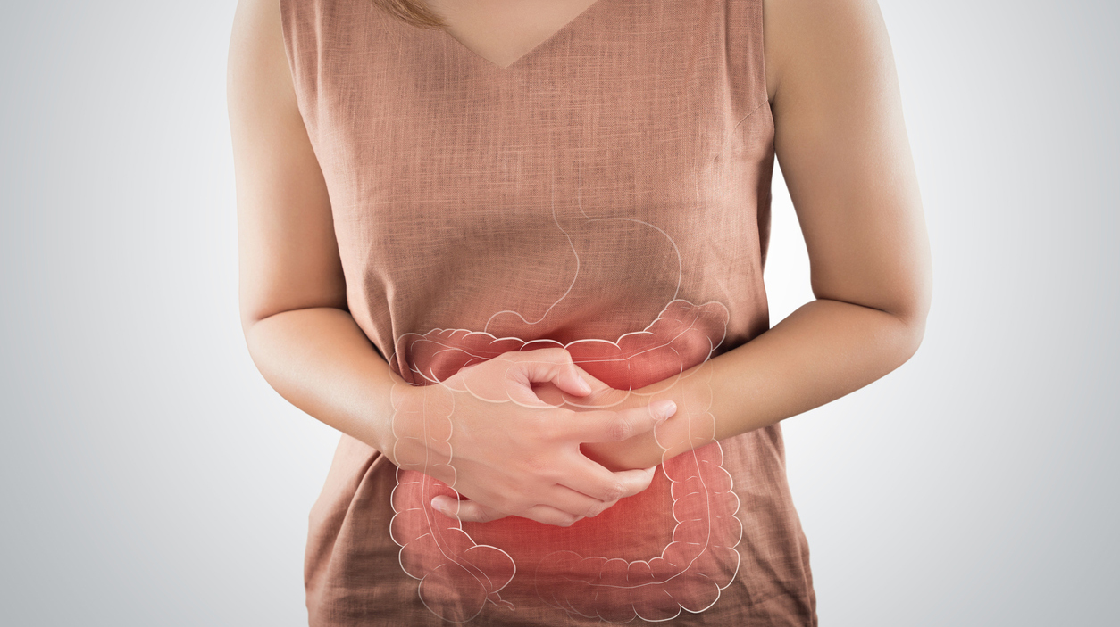 The Photo Of Large Intestine Is On The Woman’s Body. People With Stomach Ache Problem Concept. Female Anatomy
