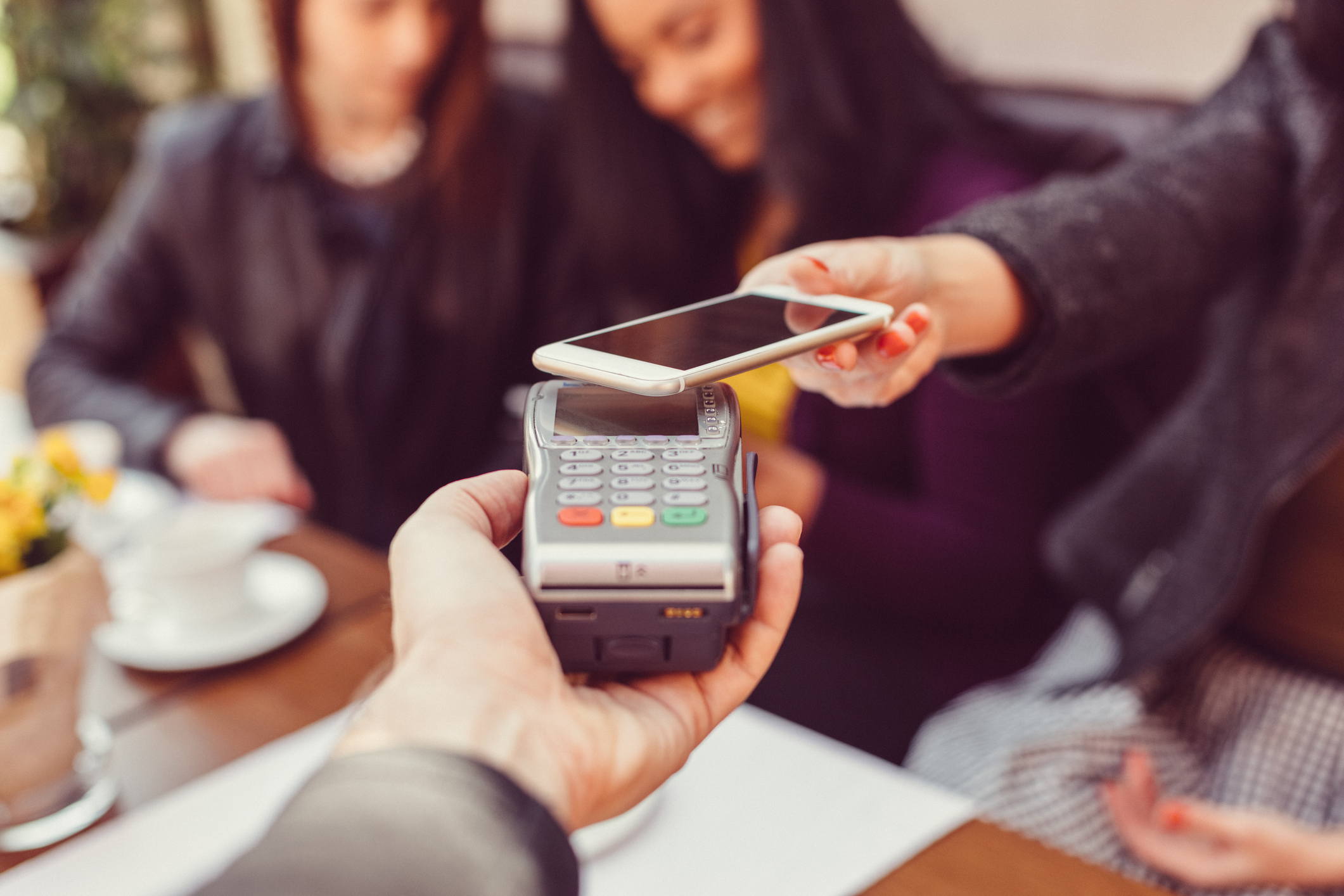 Woman making contactless payment with smartphone