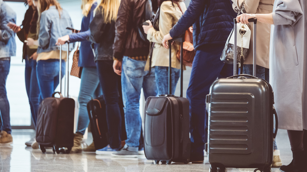 Group of people standing in queue at boarding gate