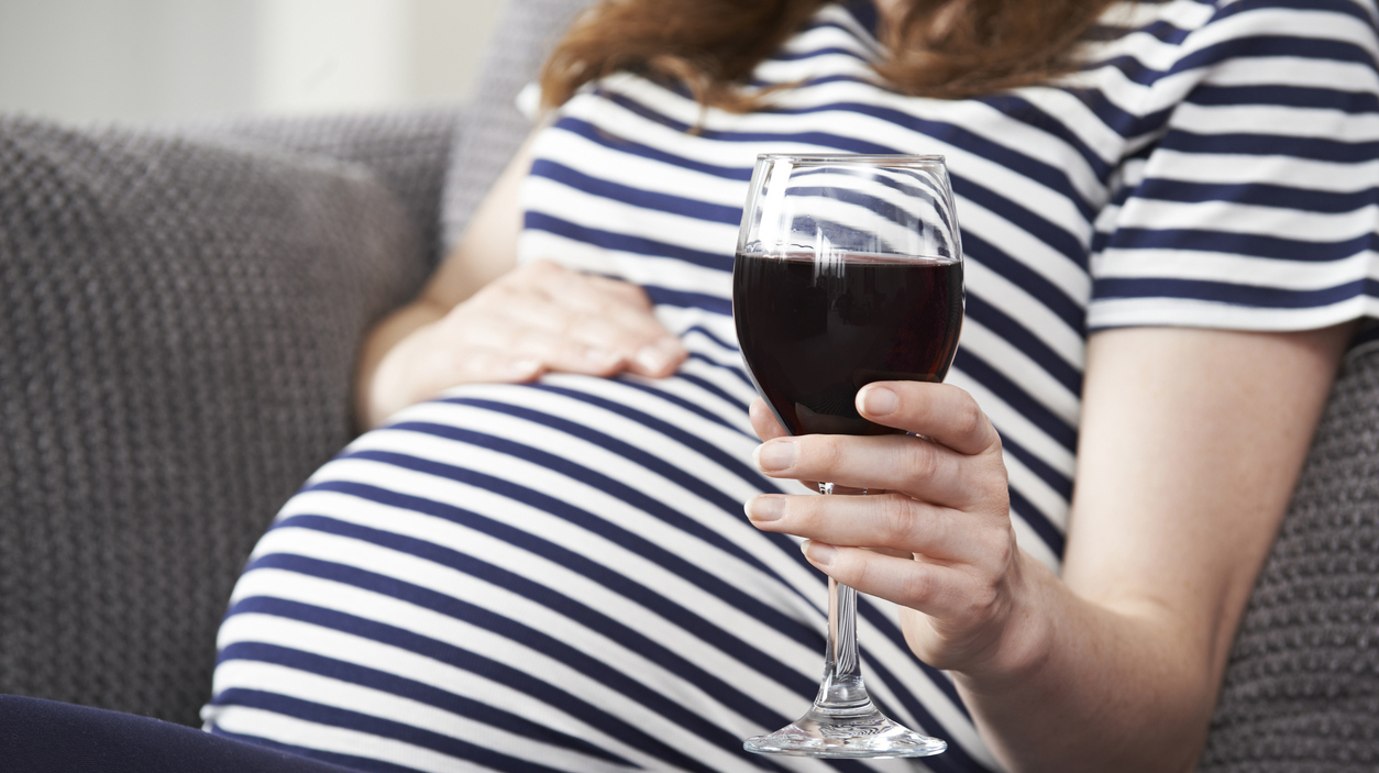 Close Up Of Pregnant Woman Drinking Red Wine