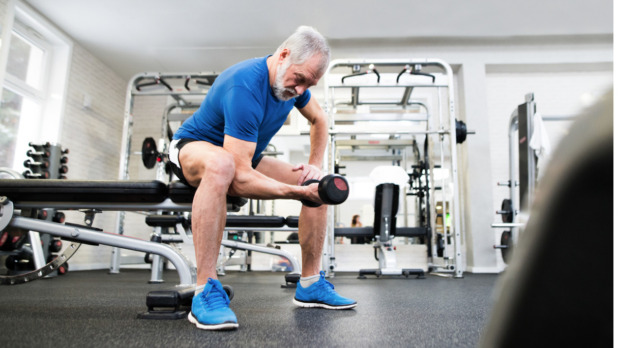 senior-man-in-gym-working-out-with-weights-picture-id638995528