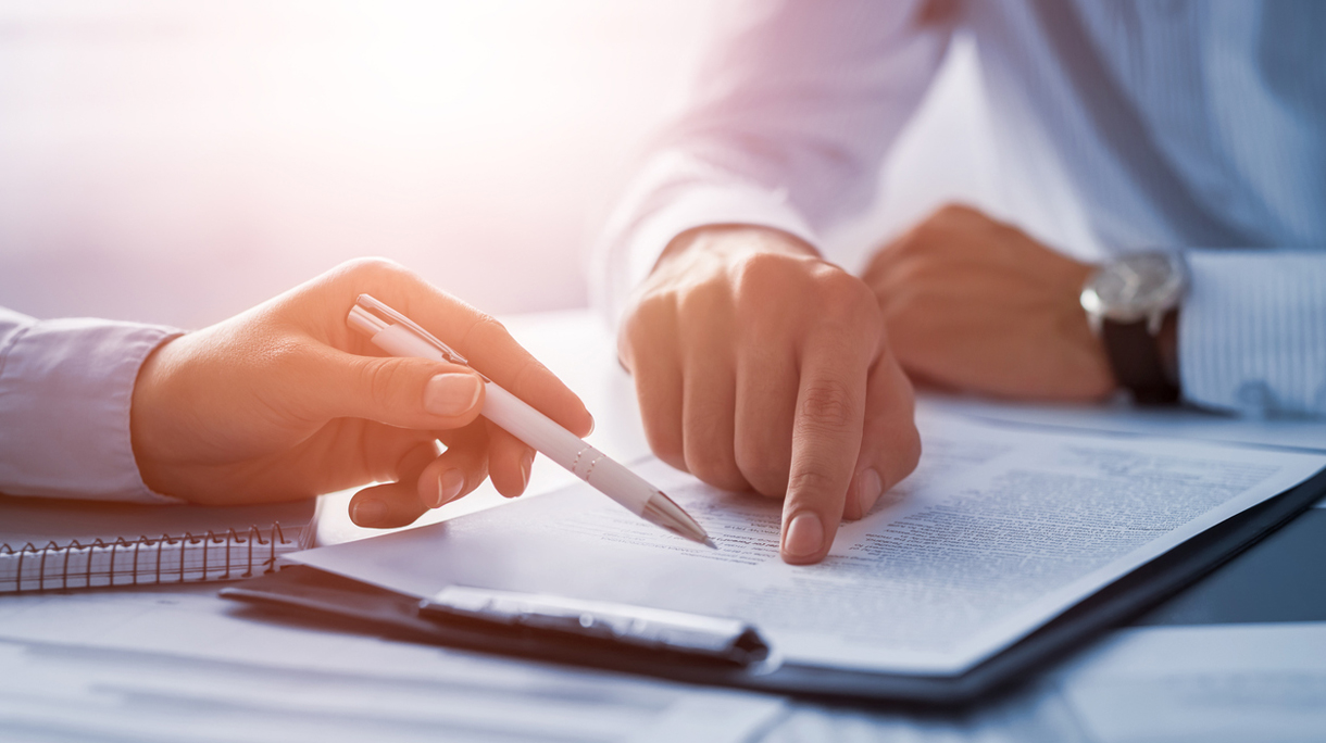 Business people negotiating a contract.