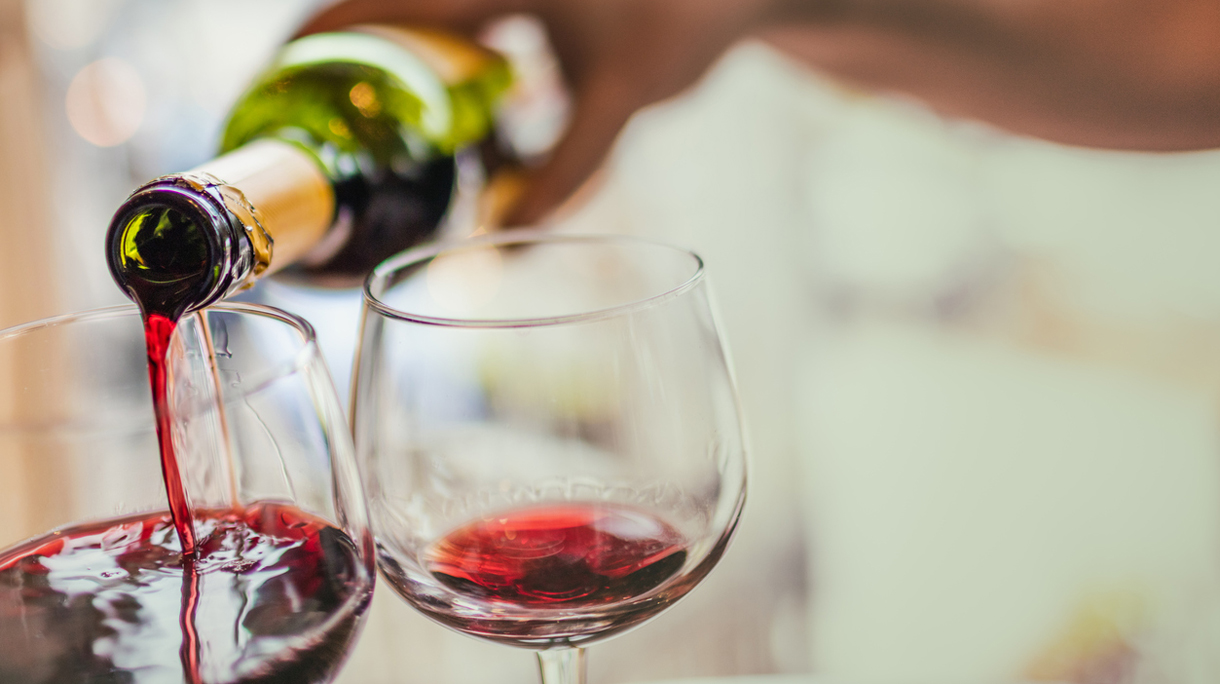 Pouring red wine in glasses
