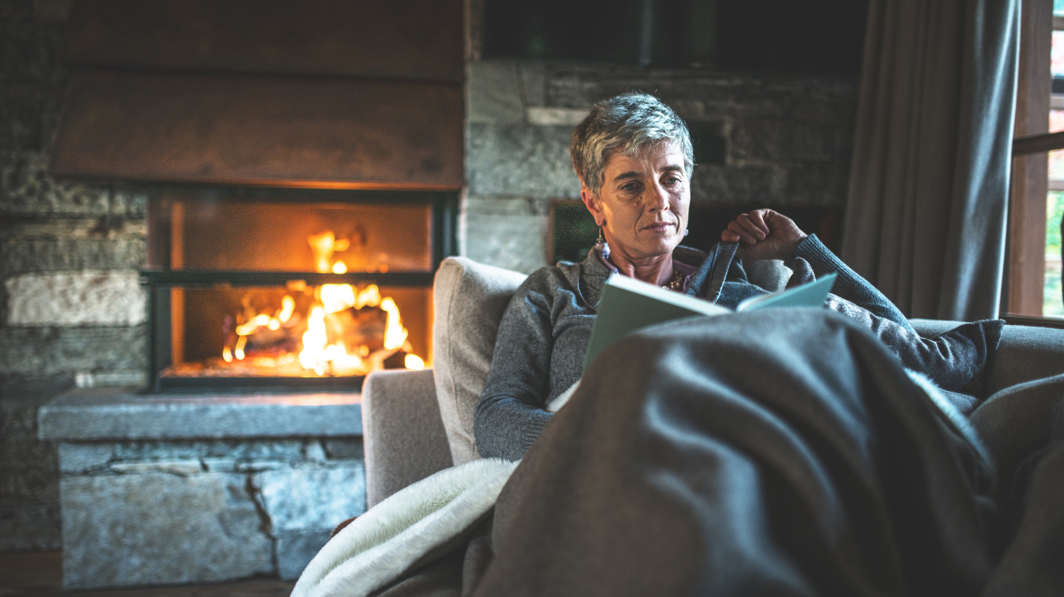 woman reading a book on the couch