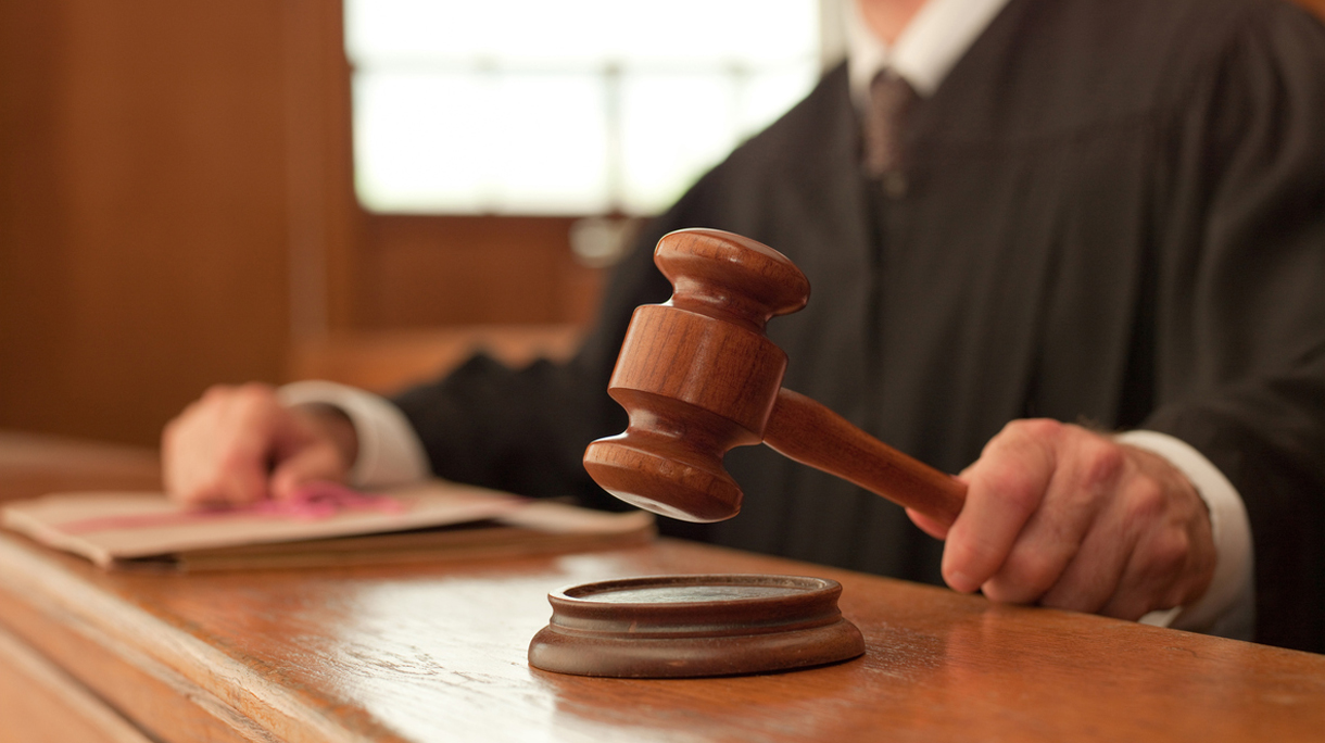 Judge holding gavel in courtroom