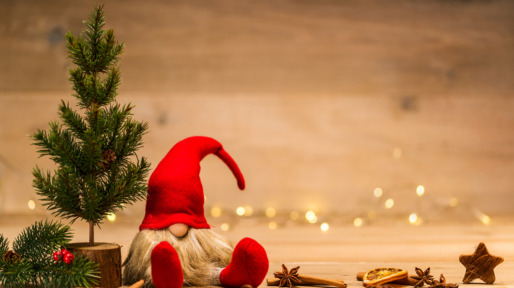 red christmas wretch next to fir tree and cinnamon sticks