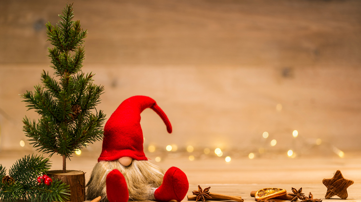 red christmas wretch next to fir tree and cinnamon sticks