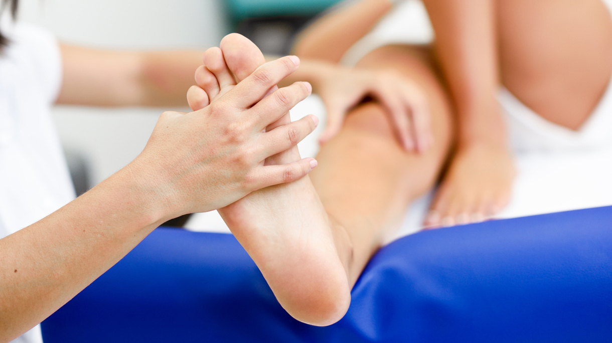 Medical massage at the foot in a physiotherapy center.