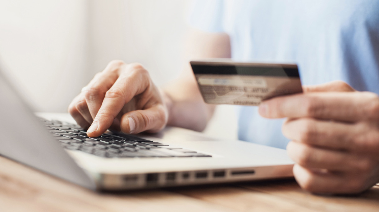 man-is-shopping-online-with-laptop-picture-id623205372