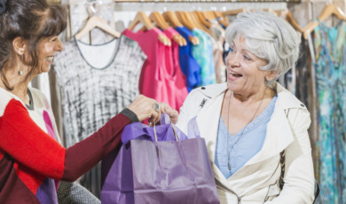 Sales assistant helping customer in clothing store