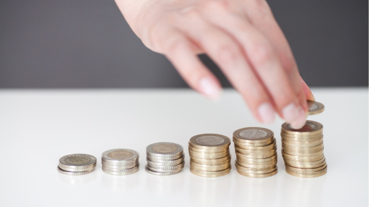 woman-put-coins-to-stack-of-coins-picture-id804005130