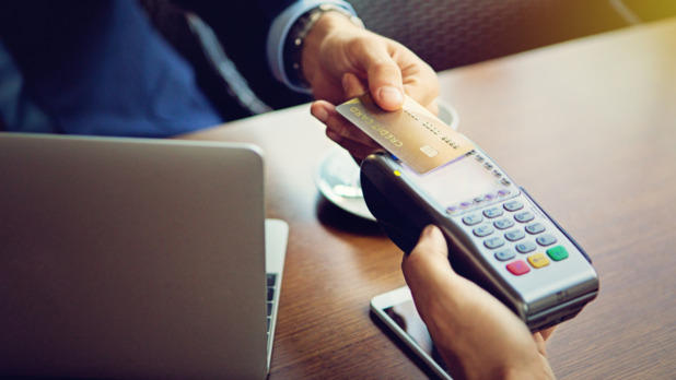 businessman-is-paying-in-the-cafe-picture-id645279618