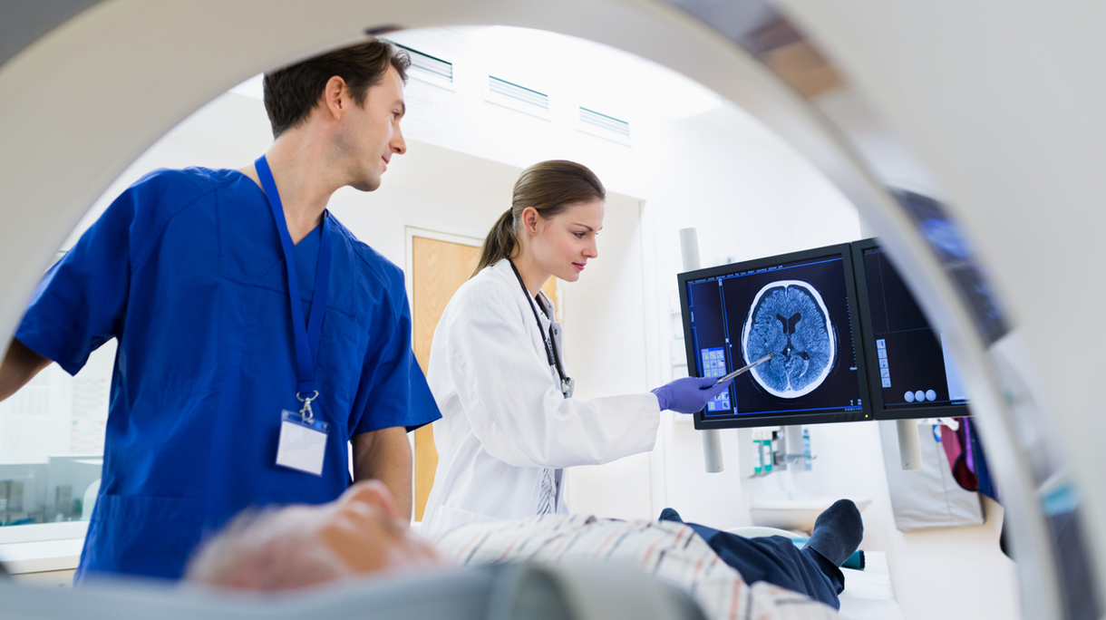 Two Doctors with Patient at CAT Scan