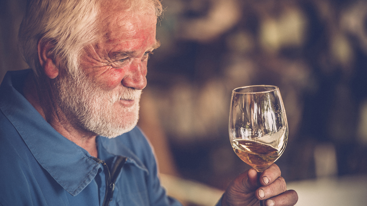Senior Man with Beard Drinking Glass of White Wine
