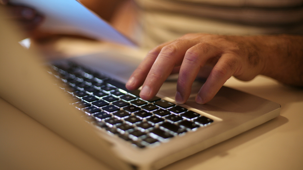 Senior man paying bills online on laptop