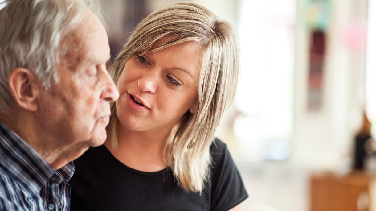 Assistant In The Community Center Helping A Senior Men