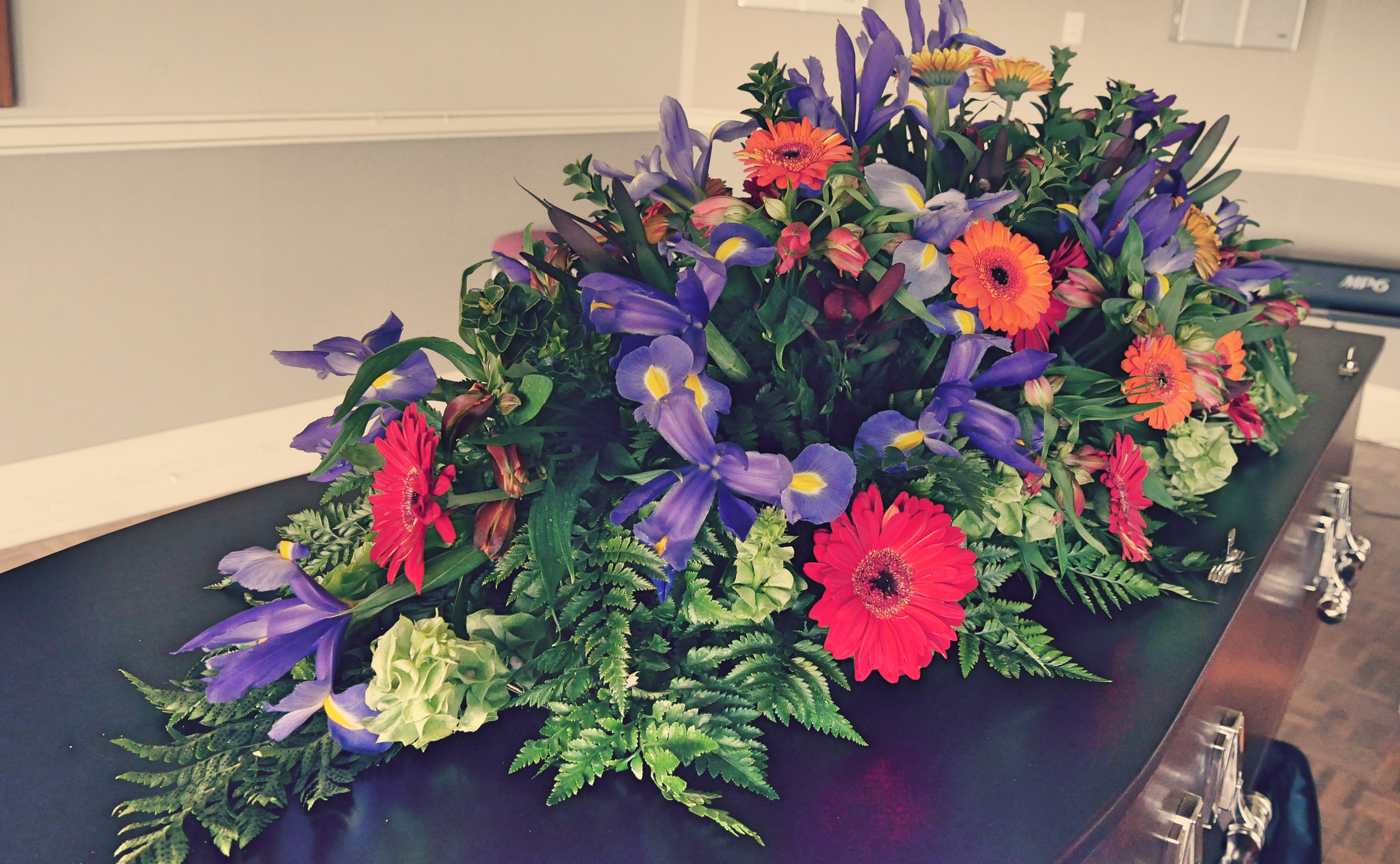 shot of a colorful casket in a hearse or chapel before funeral or burial at cemetery