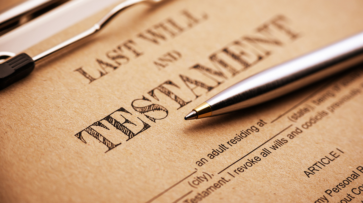 Blue ballpoint pen and a last will and testament.