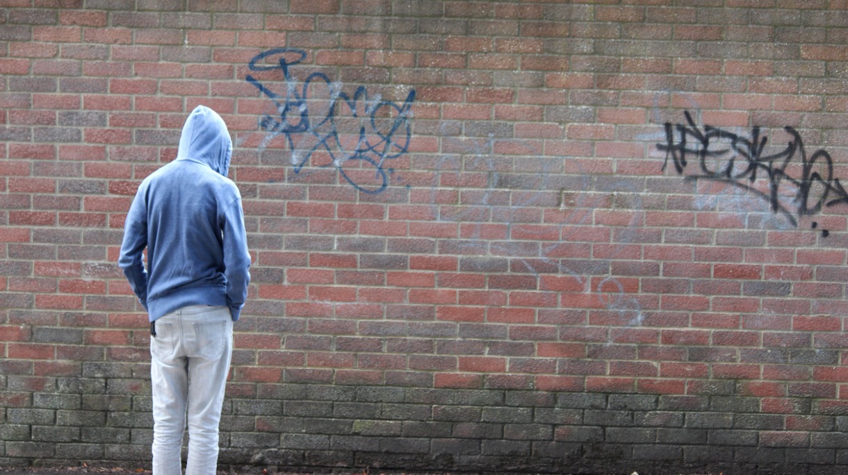 image-of-teenage-boy-youth-wearing-hoodie-beside-graffiti-wall-picture-id504823425