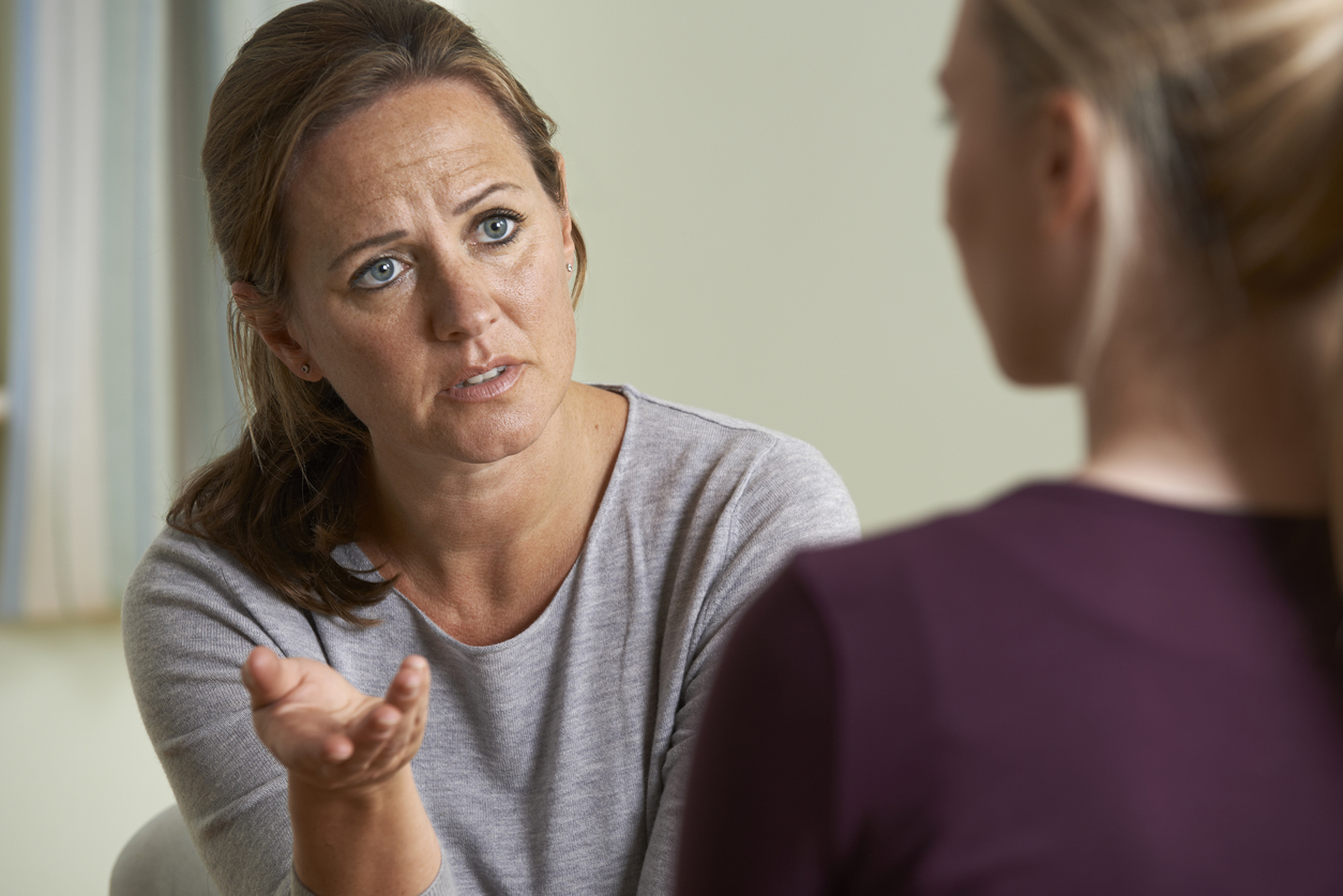 Mature Woman Discussing Problems With Counselor