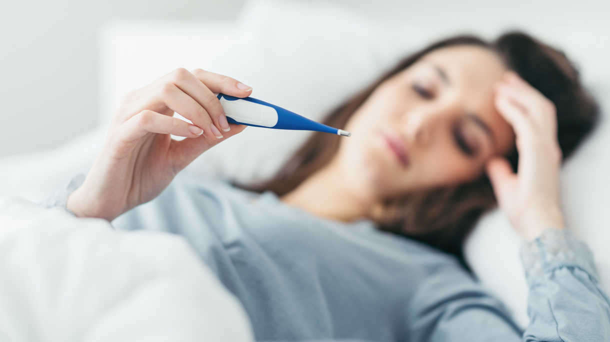 Woman measuring her temperature