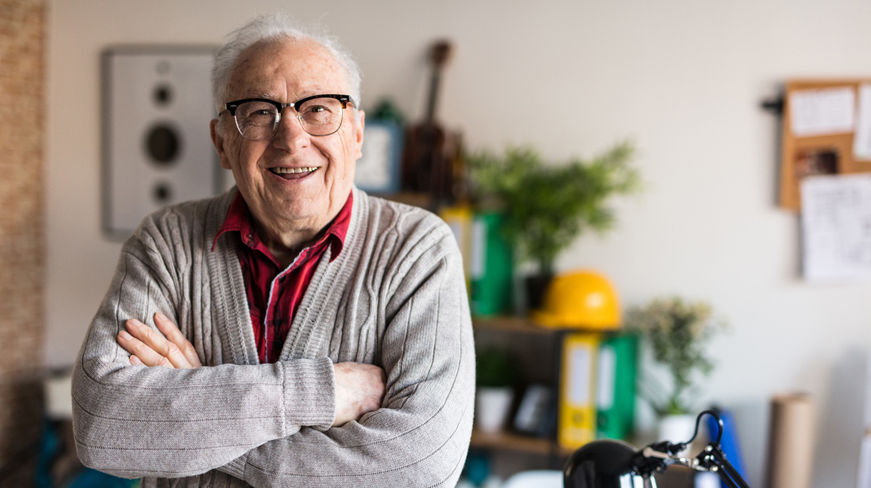 Smiling active senior with arms crossed