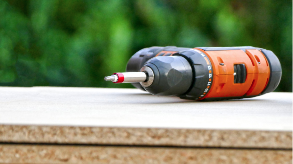 carpenters-battery-drill-is-lying-on-the-construction-site-picture-id840230446