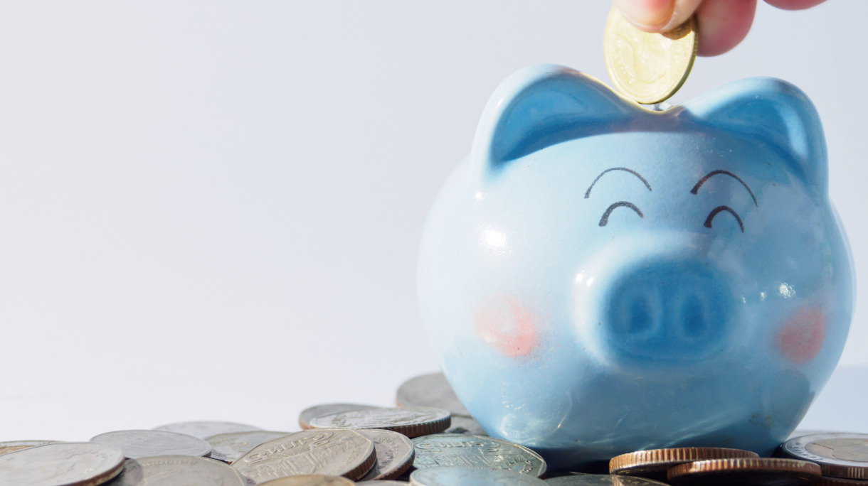 cute-blue-piggy-bank-and-hand-picking-coin-drop-in-piggy-bank-picture-id840788658