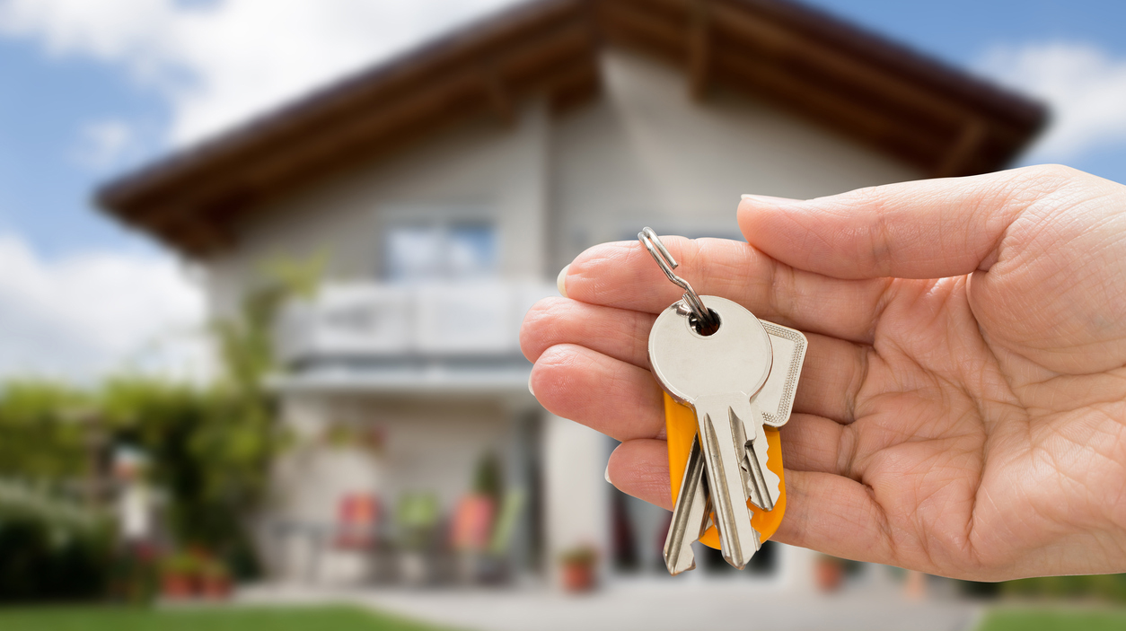 Person Hand Holding House Key