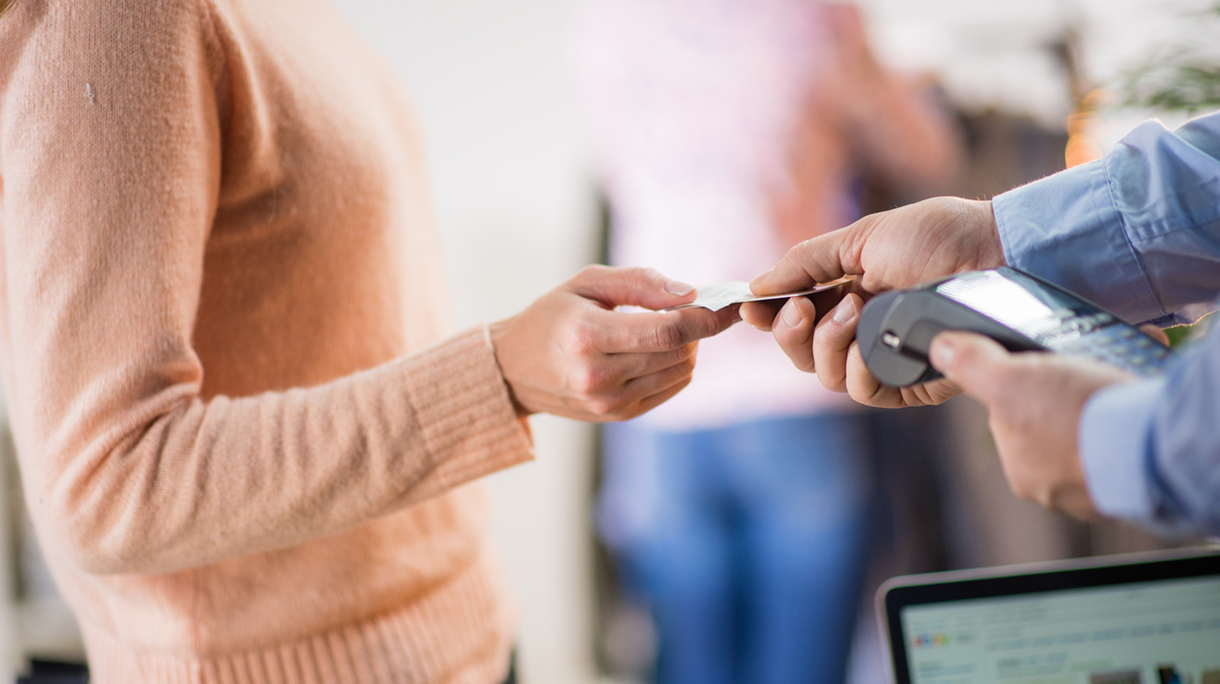 Man giving credit card to woman