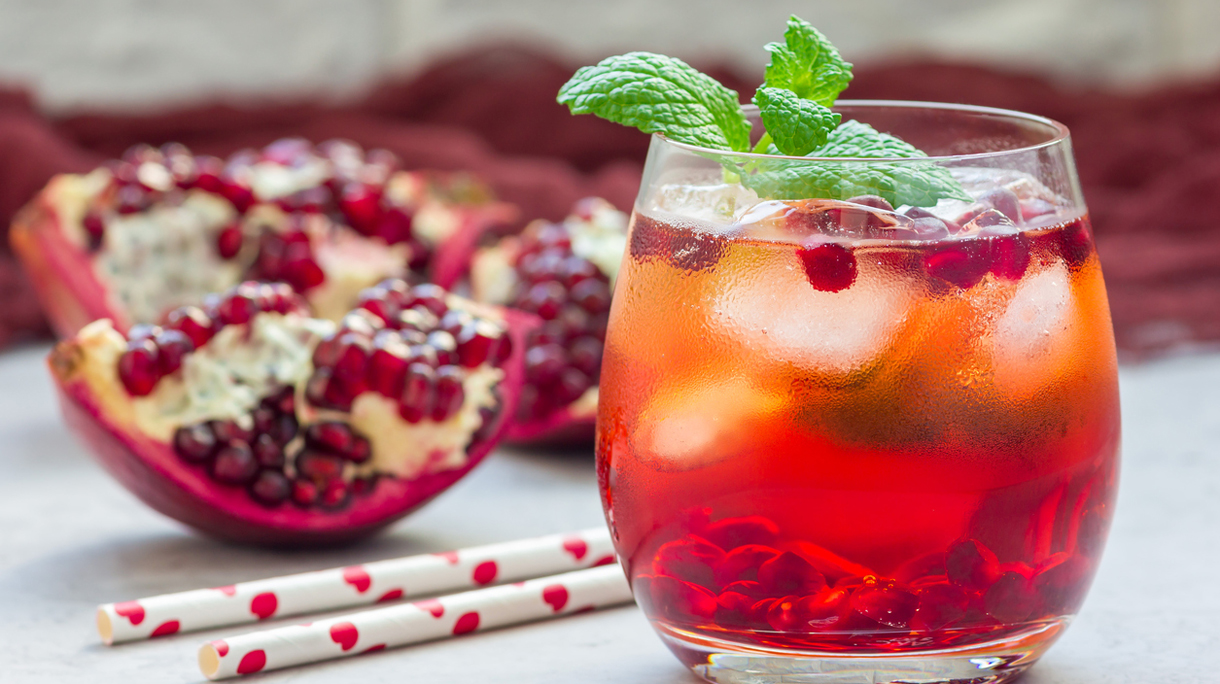 Mojito cocktail with pomegranate, mint, lemon juice and ice, horizontal