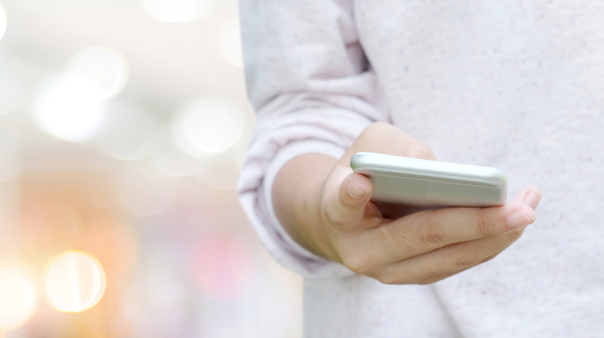 Hand using smart phone over blur bokeh light background, business and technology concept, digital marketing, seo, e-commerce, network, internet of things