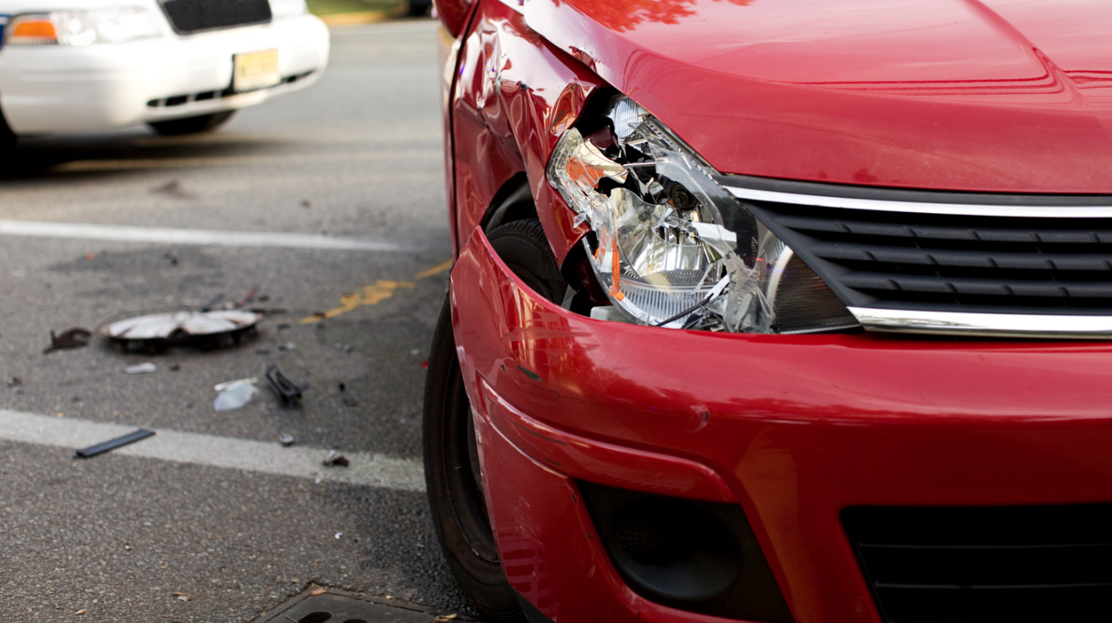 red-car-with-a-damaged-headlight-after-an-accident-picture-id175195079