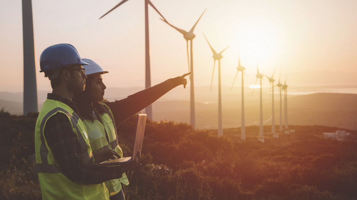 young-maintenance-engineer-team-working-in-wind-turbine-farm-at-picture-id831152982