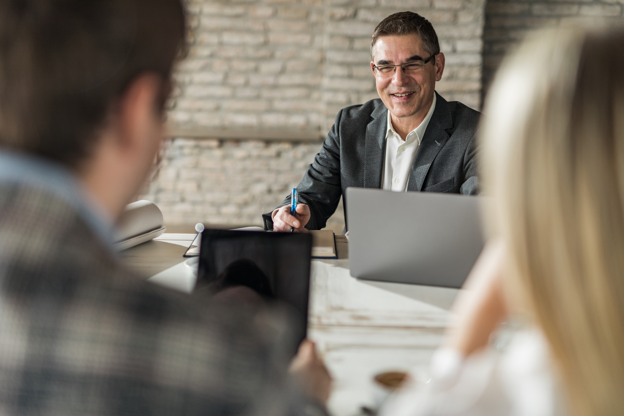 Happy insurance agent having a meeting with his customers in the office.