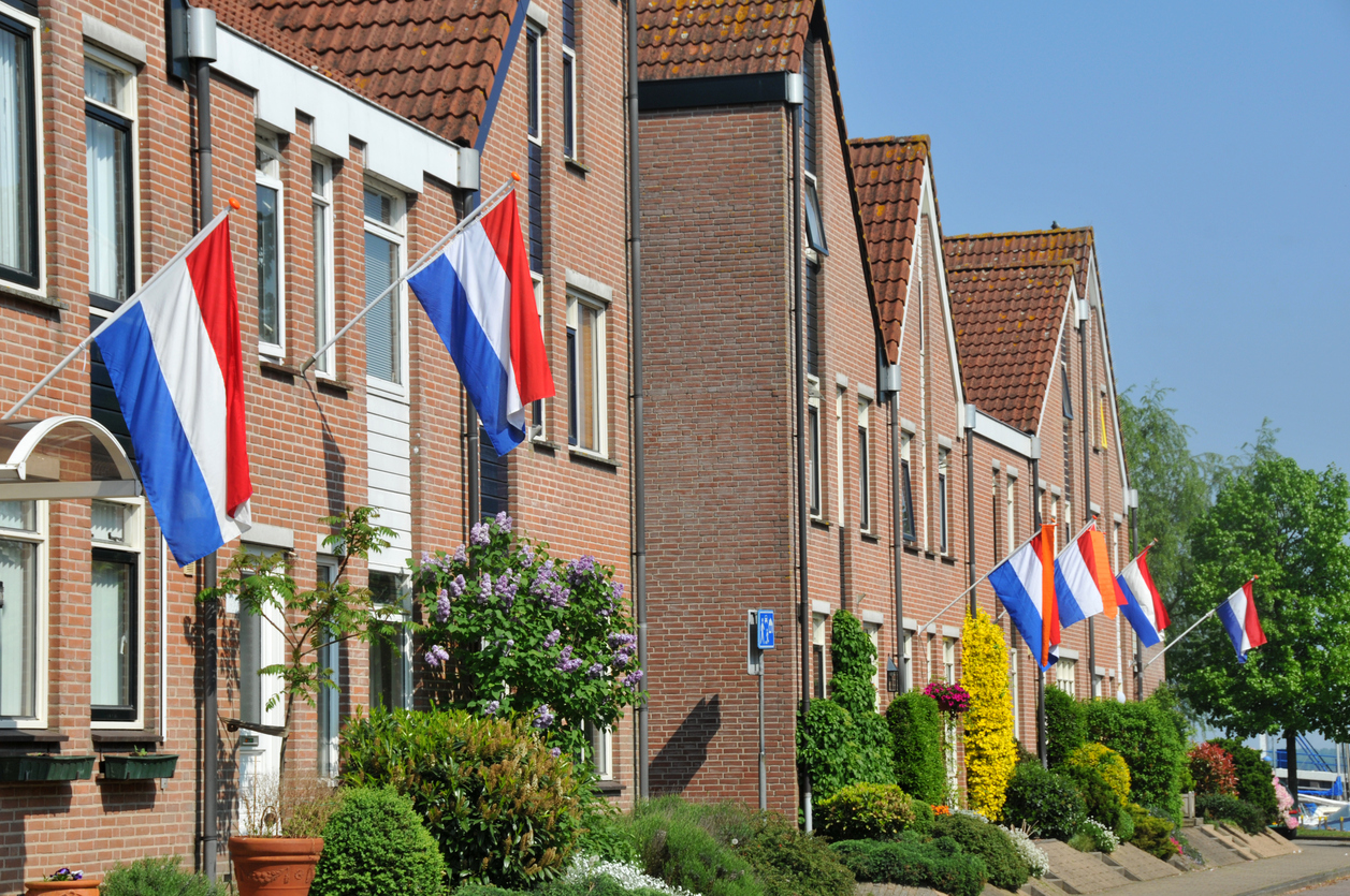 Houses with Dutch flags on sunny day