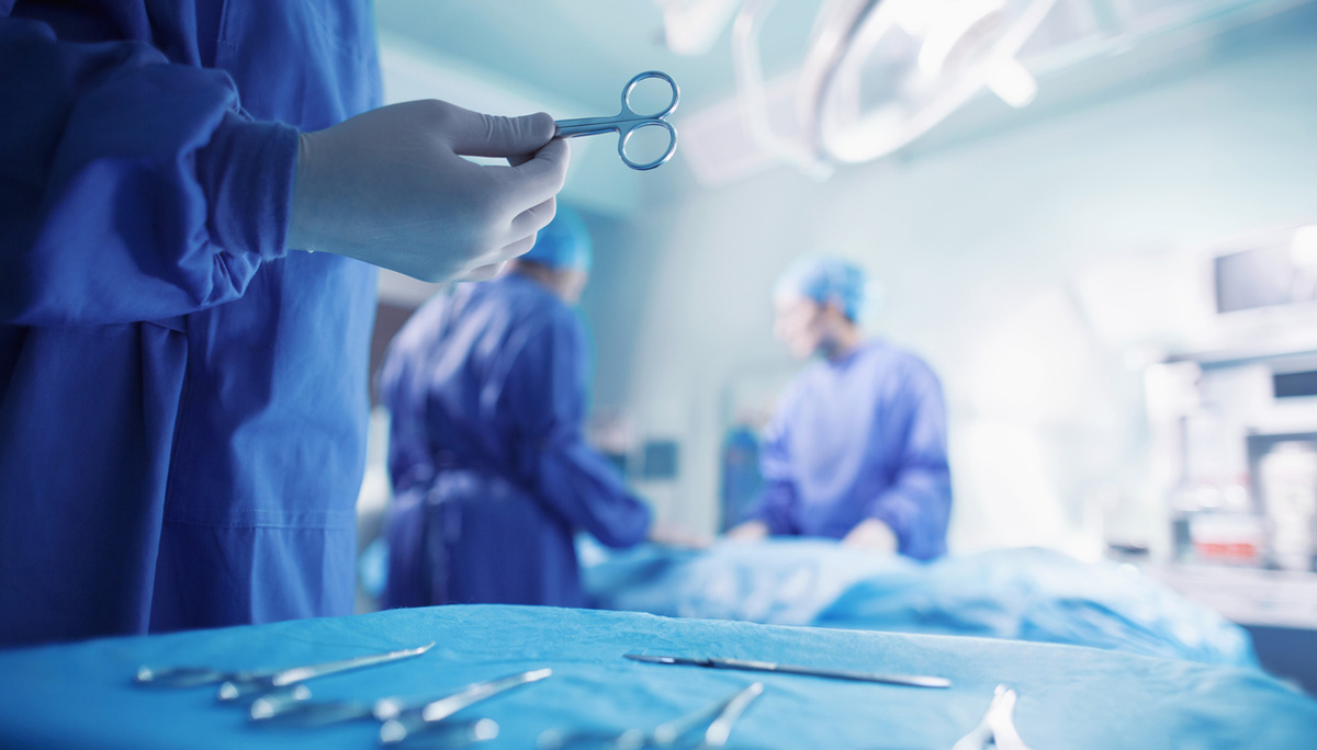 Doctors performing surgery in hospital operating room