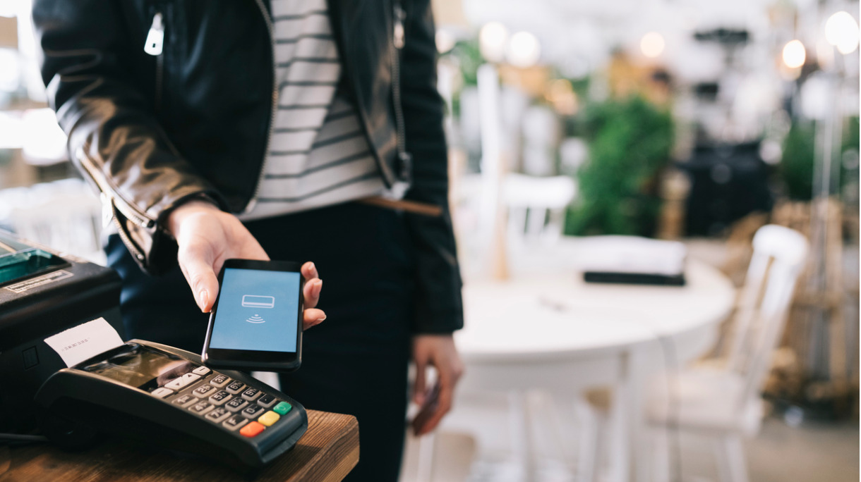 woman-paying-with-smartphone-picture-id814541224