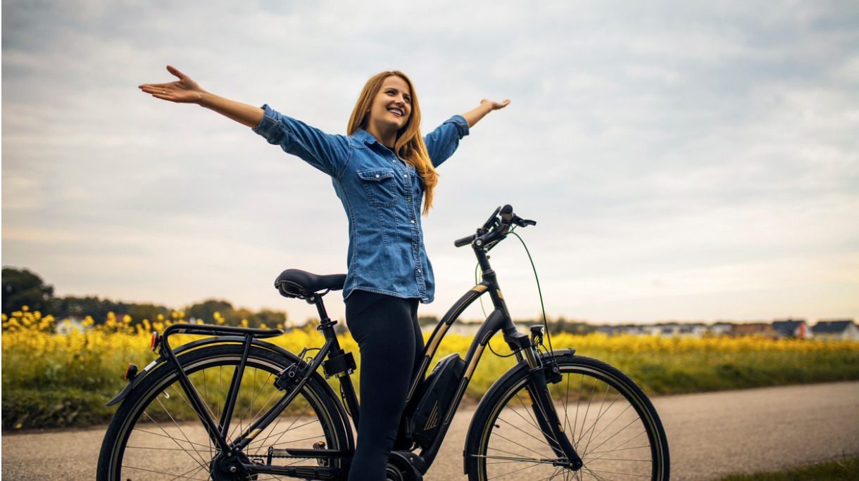 woman-riding-on-her-electric-bike-picture-id876534856
