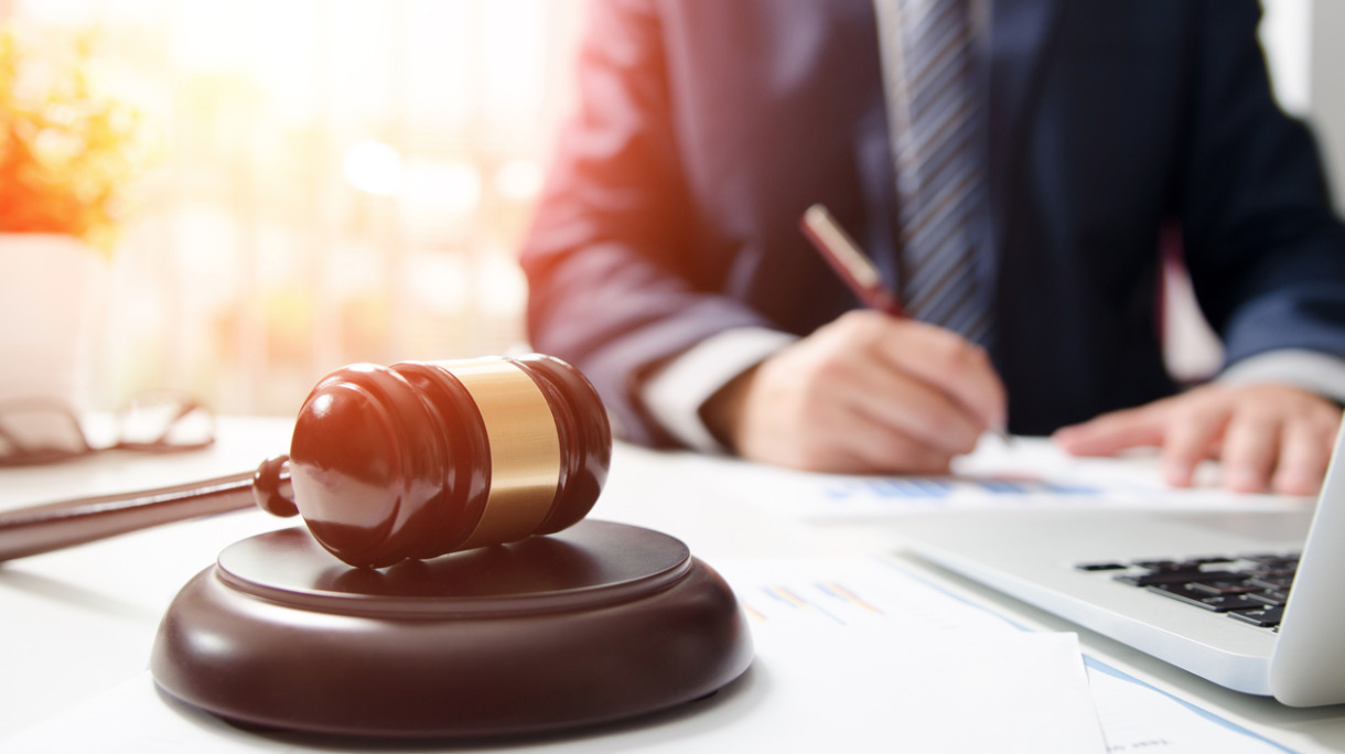 wooden-gavel-on-table-attorney-working-in-courtroom-picture-id850906706