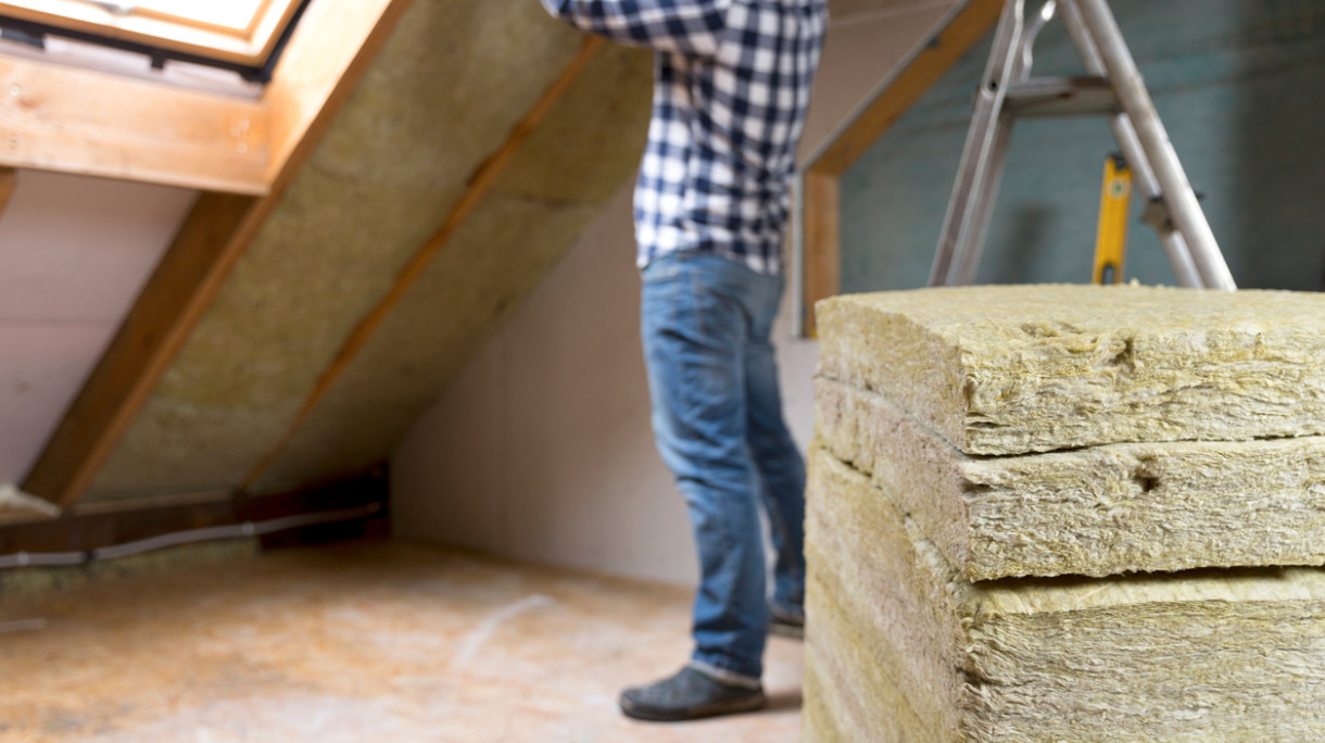 man-installing-thermal-roof-insulation-layer-using-mineral-wool-picture-id873936796