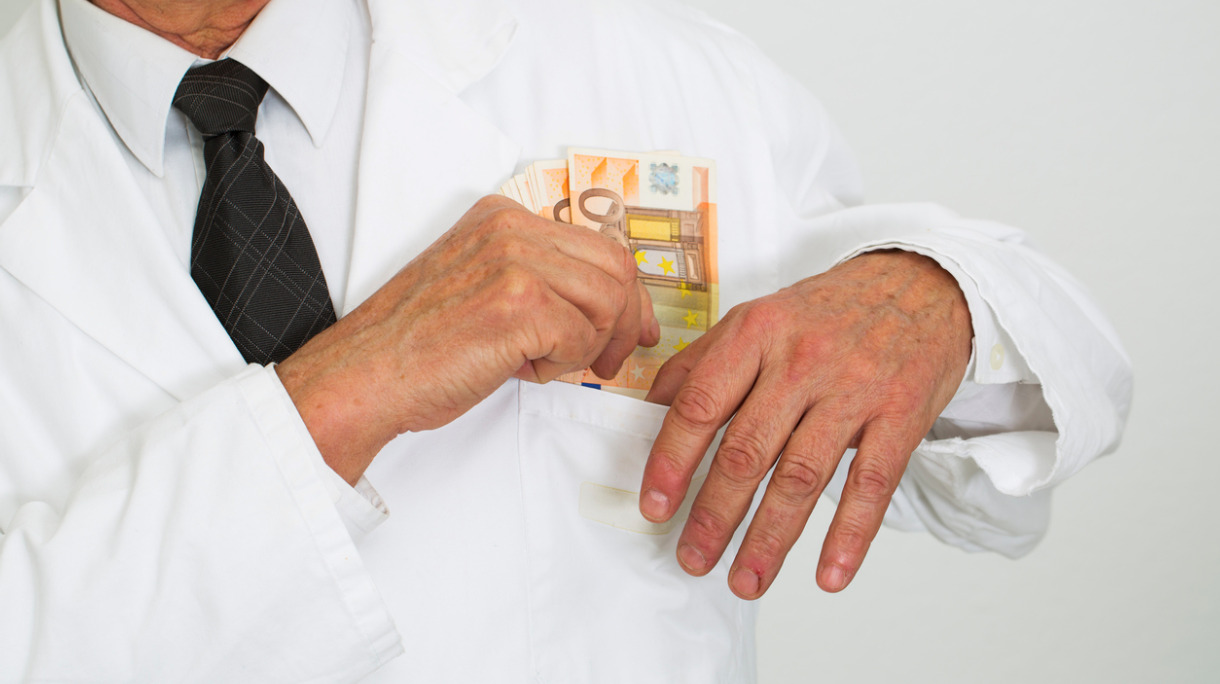 corrupted-doctor-taking-bribes-moneywhite-collar-crime-picture-id526980921