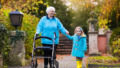 Senior lady with walker enjoying family visit in the park