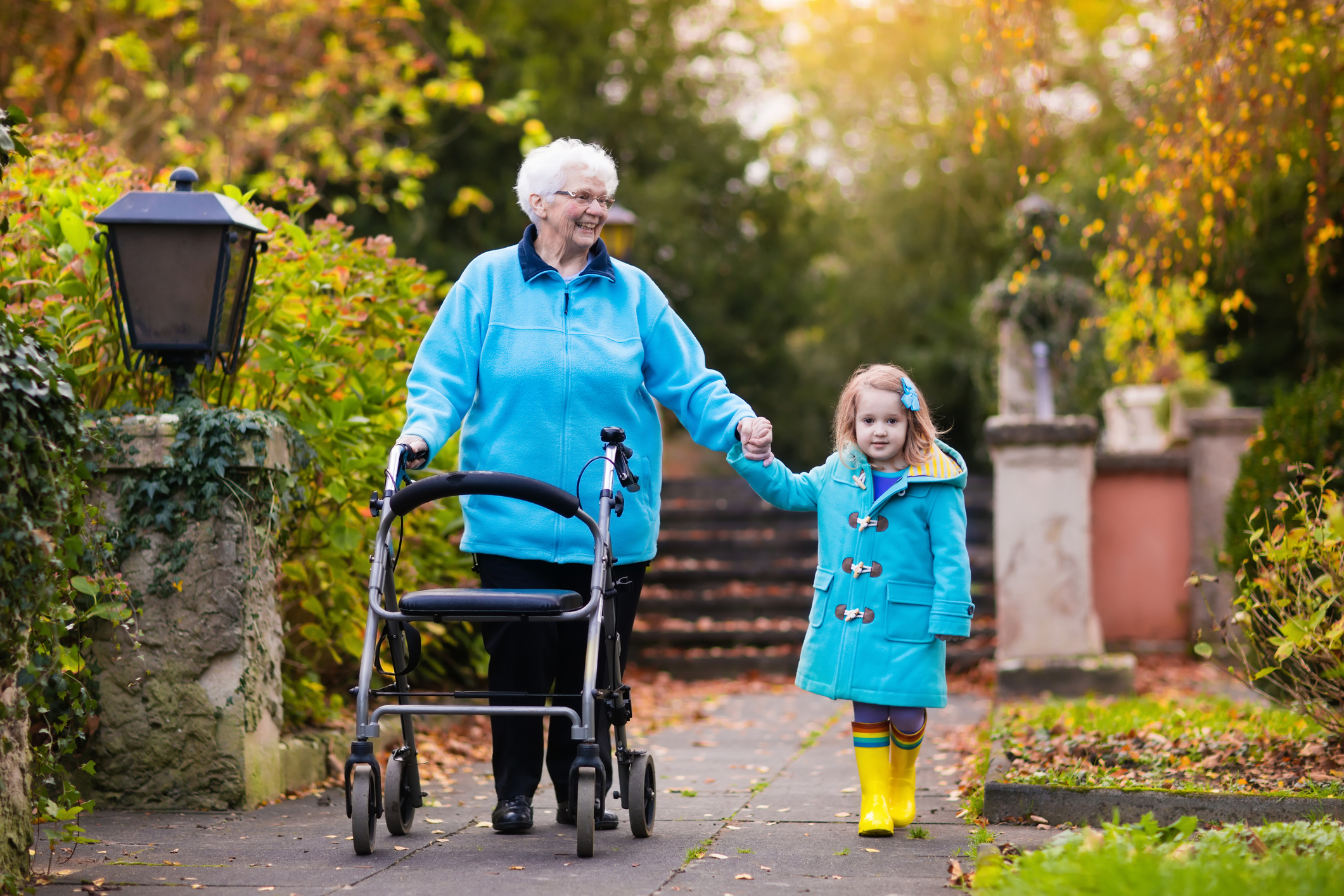 Senior lady with walker enjoying family visit in the park