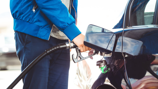 Man pumping fuel in car at gas station