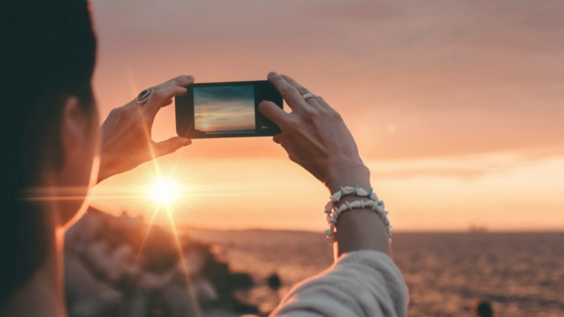 woman-photographing-the-sunset-picture-id505244006_0