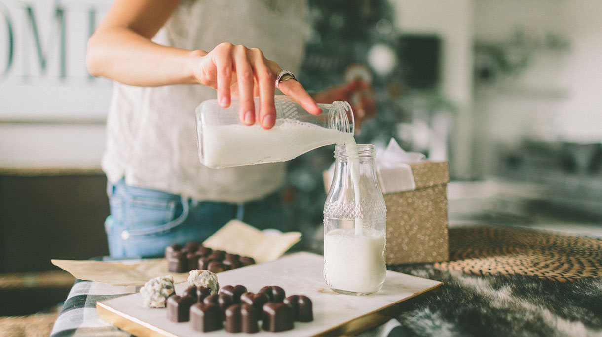 Midsection Of Women Pouring Milk