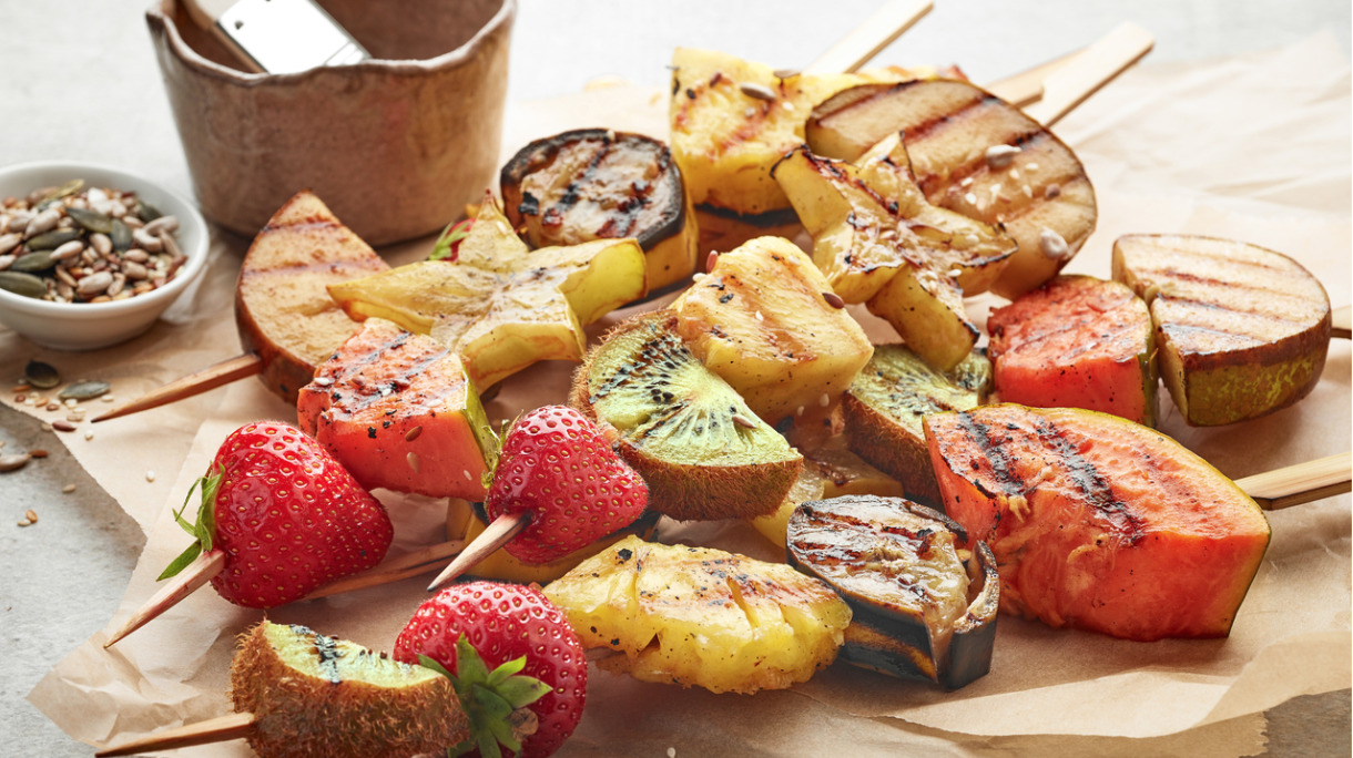 grilled-fruit-pieces-on-wooden-skewers-picture-id577618190