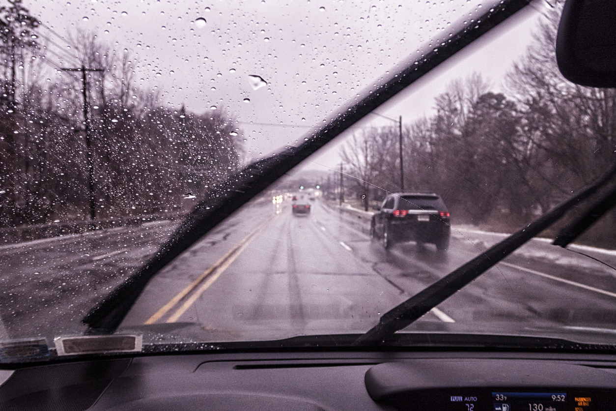 Car Driver POV Through Windshield on Rainy Sloppy Winter Highway