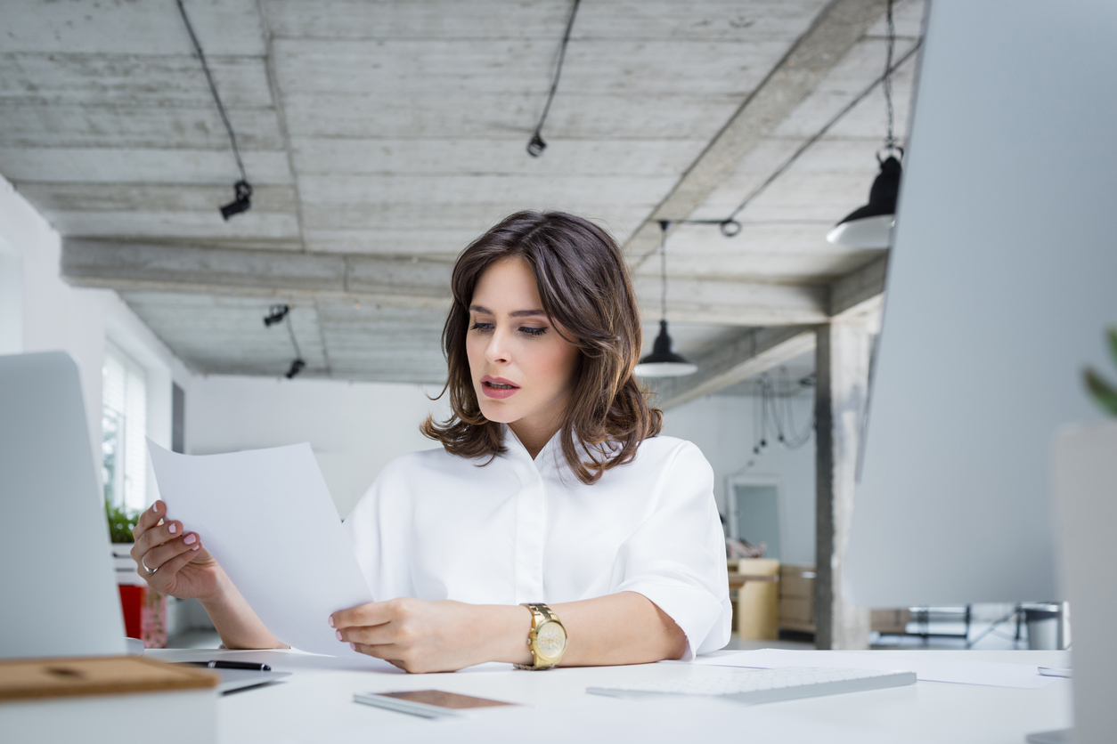 Worried businesswoman reading a document